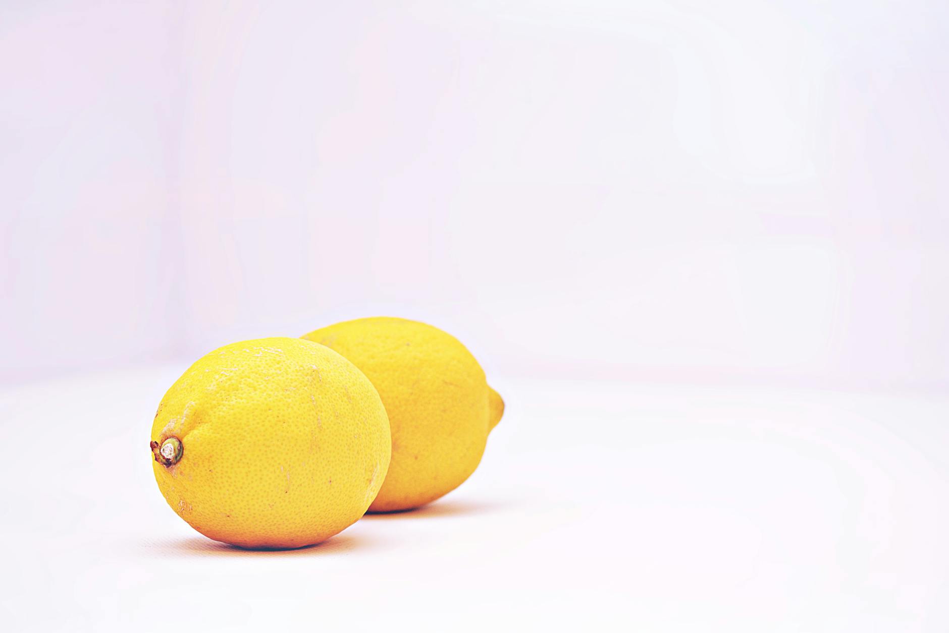 Two vibrant lemons on a white background