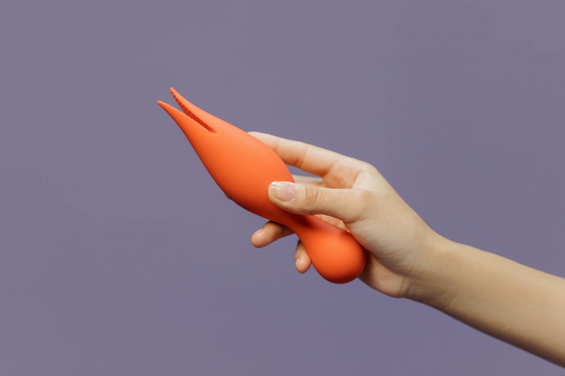 Close-up of someone holding a vibrator, symbolizing taking control of personal pleasure