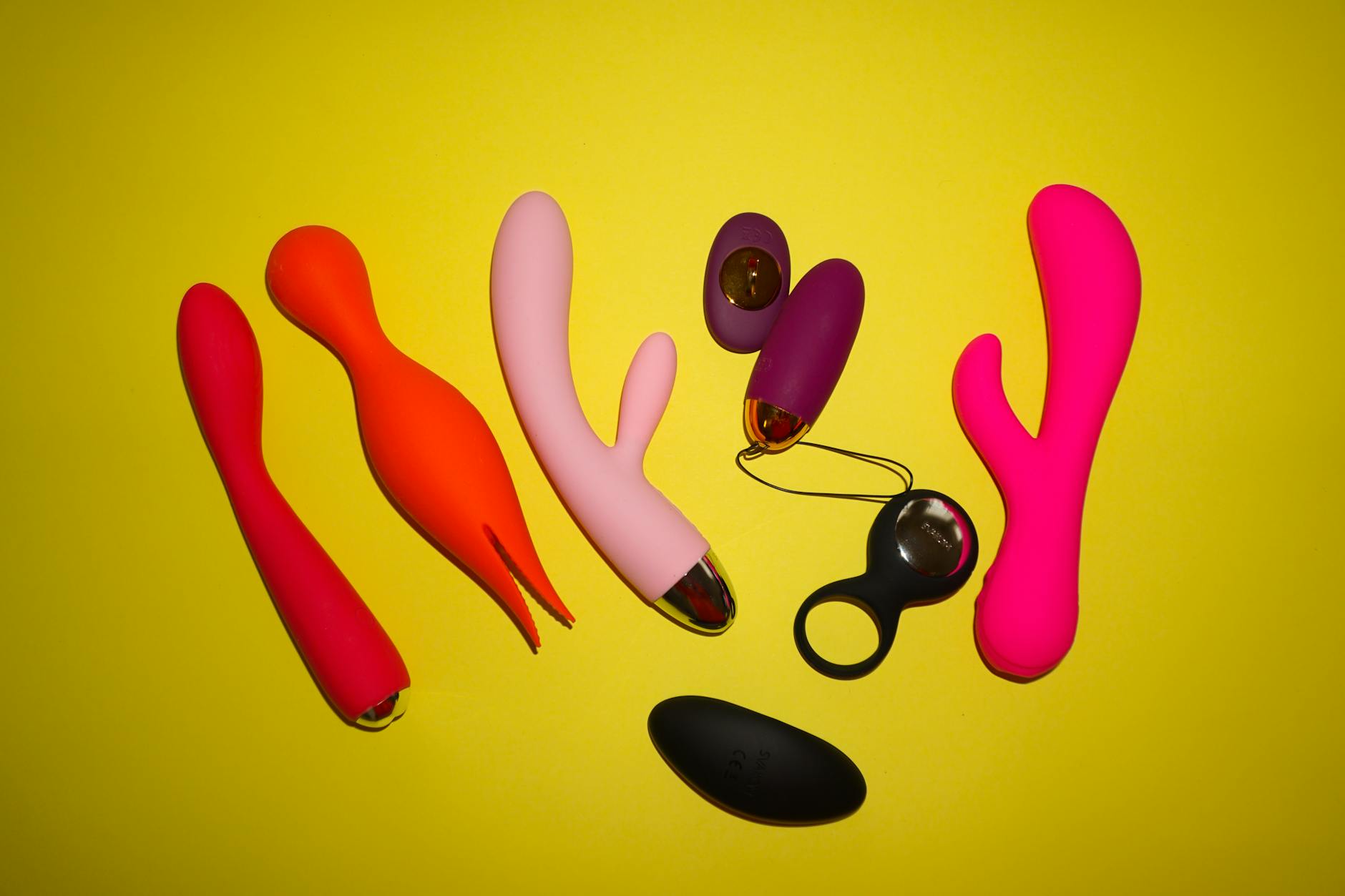 A collection of colorful vibrators displayed on a bright surface