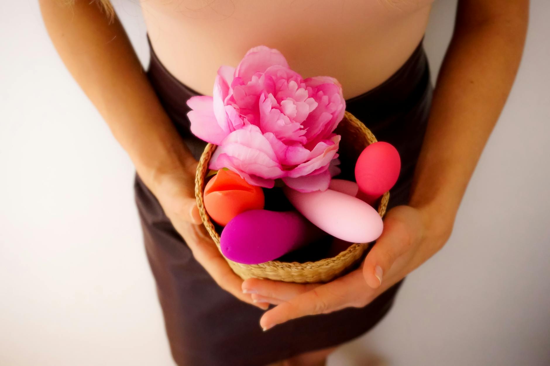 A basket of colorful vibrators and pleasure products displayed together